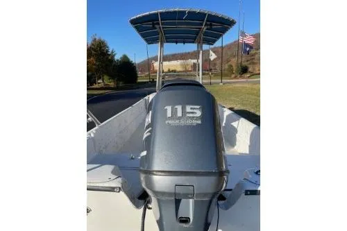 Slide: The Image of 2006 Carolina Skiff 198 DLX boat with 115 horsepower engine, parked outdoors. - 5