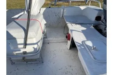 Slide: The Image of 2006 Carolina Skiff 198 DLX boat interior with seating and storage compartments. - 6