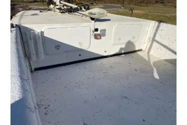 Slide: The Image of 2006 Carolina Skiff 198 DLX boat interior with storage compartments and trolling motor. - 8