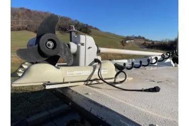 Slide: The Image of Trolling motor on a 2006 Carolina Skiff 198 DLX boat, scenic countryside background. - 9