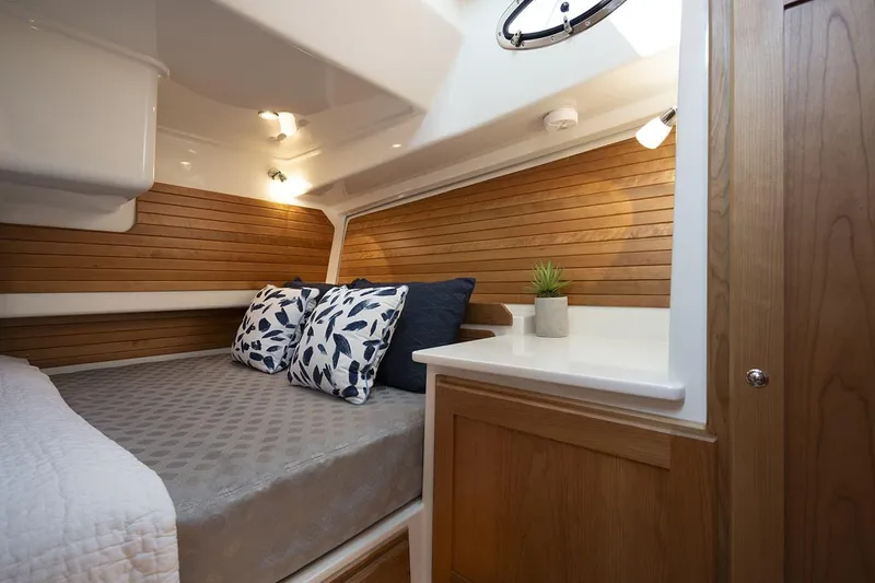 Slide: The Image of Manufacturer Provided Image: Cozy cabin interior of 2026 Back Cove 412 yacht with wood paneling and decorative pillows. - 10