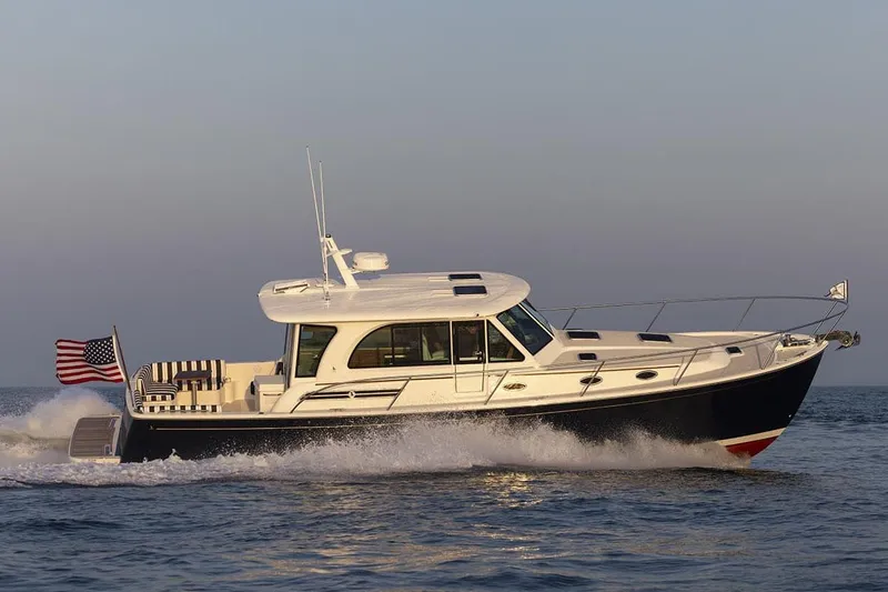 Slide: The Image of Manufacturer Provided Image: 2026 Back Cove 412 yacht cruising on open water at sunset. - 2