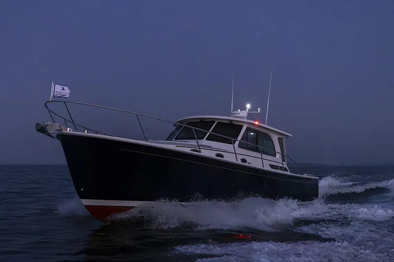 Slide: The Image of Manufacturer Provided Image: 2026 Back Cove 412 yacht cruising at dusk on open water. - 3