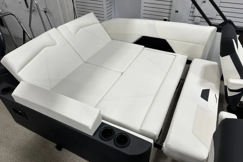 Slide: The Image of Luxurious white seating in 2026 Evotti 521CS boat interior, featuring modern design and cup holders. - 7