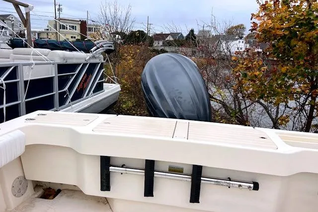 Slide: The Image of 2005 Parker 2320 SL Sport Cabin boat with outboard motor, docked near autumn foliage. - 12