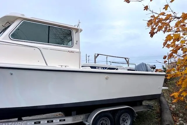 Slide: The Image of 2005 Parker 2320 SL Sport Cabin boat on trailer, autumn leaves nearby. - 2