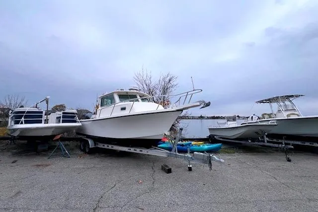 Slide: The Image of 2005 Parker 2320 SL Sport Cabin boat on trailer, parked outdoors. - 3