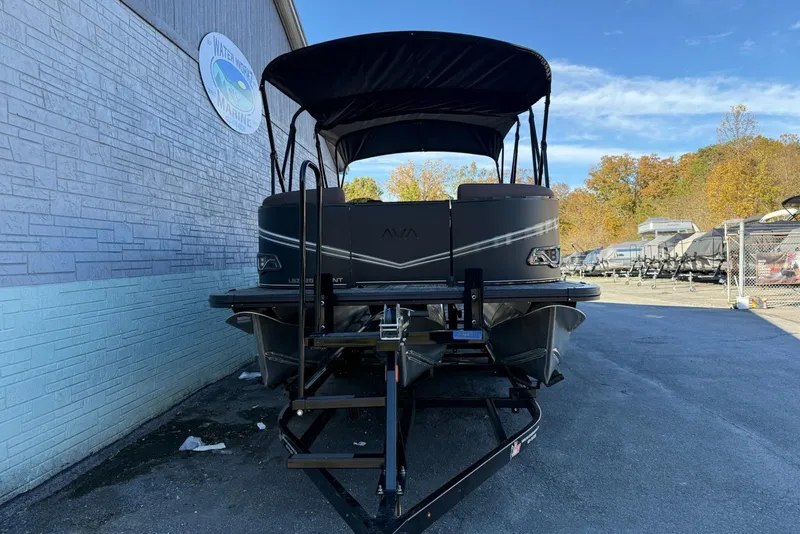 Slide: The Image of 2026 Avalon 2585 LSZ Entertainer pontoon boat on trailer, parked outdoors. - 3