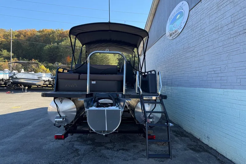 Slide: The Image of 2026 Avalon 2585 LSZ Entertainer pontoon boat parked near a marine shop. - 5