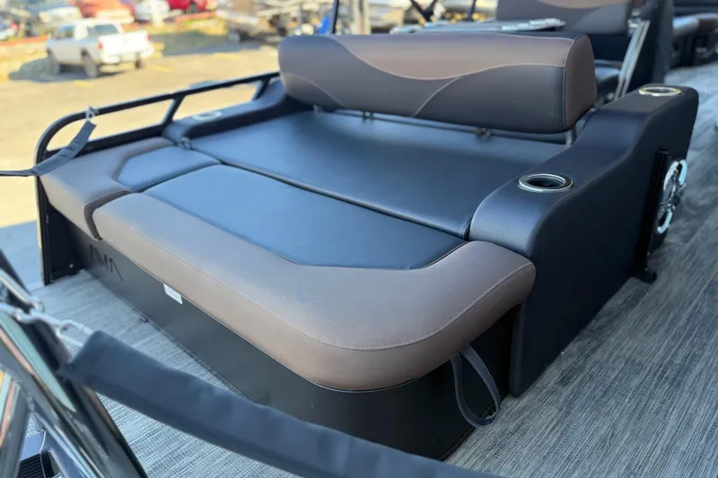 Slide: The Image of 2026 Avalon 2585 LSZ Entertainer boat seating with cup holders, outdoor setting. - 7