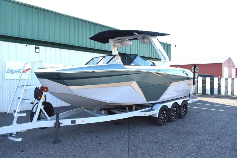 The Image of 2026 Tigé Z3 boat on trailer, parked outside a green building. - 0