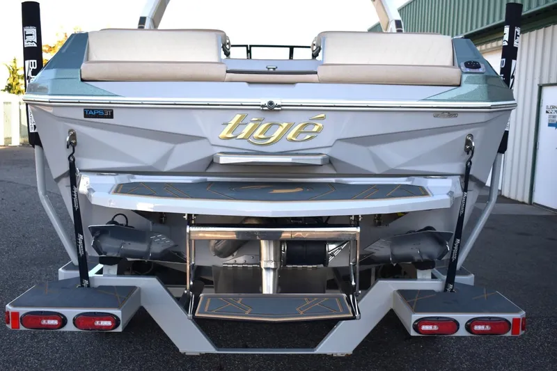 Slide: The Image of 2026 Tigé Z3 boat rear view with TAPS 3T system, parked outdoors. - 18