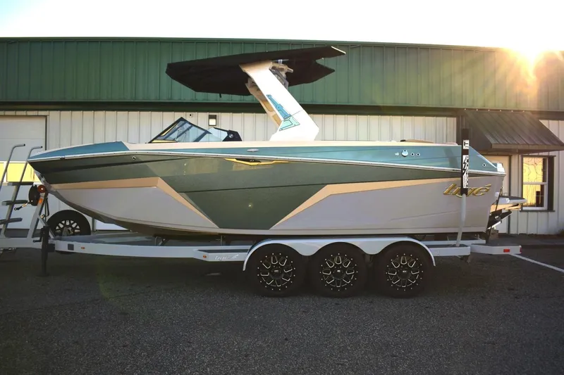 Slide: The Image of 2026 Tigé Z3 boat on trailer, parked outside, sunlit background. - 3
