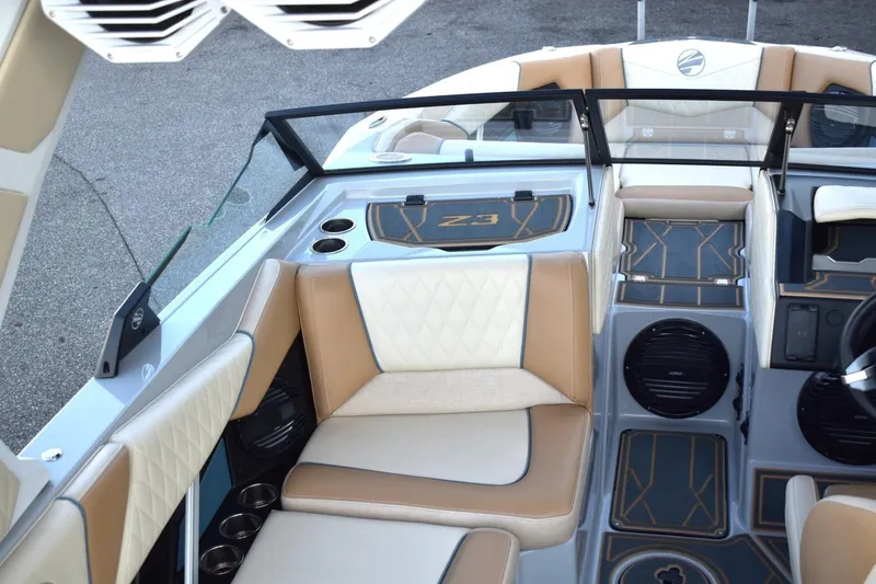 Slide: The Image of 2026 Tigé Z3 boat interior with beige and white seating, modern dashboard, and cup holders. - 30