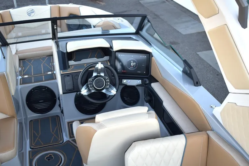 Slide: The Image of 2026 Tigé Z3 boat interior with modern dashboard, steering wheel, and beige seating. - 31
