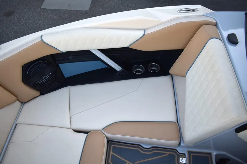 Slide: The Image of 2026 Tigé Z3 boat interior with beige and white cushioned seating, featuring cup holders and speaker. - 41