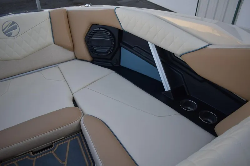 Slide: The Image of 2026 Tigé Z3 boat interior with beige and tan seating, cup holders, and speaker. - 53
