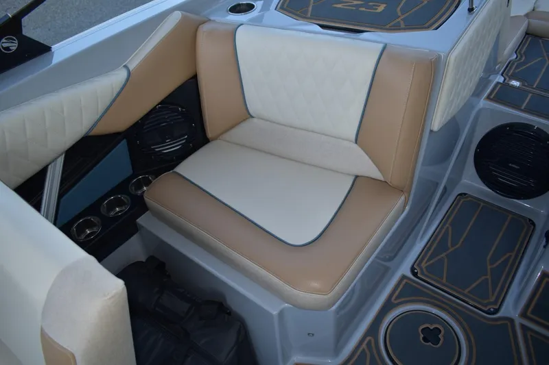 Slide: The Image of 2026 Tigé Z3 boat interior with tan and cream seating, featuring cup holders and speakers. - 64