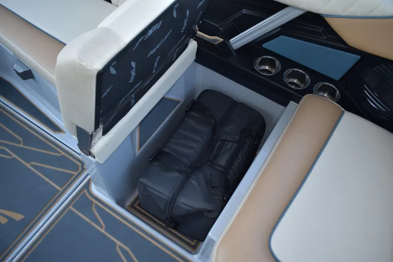 Slide: The Image of 2026 Tigé Z3 boat interior storage with black bag and cup holders. - 65