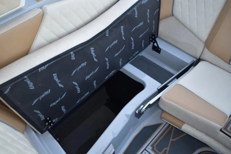 Slide: The Image of 2026 Tigé Z3 boat interior storage compartment with beige and tan seating. - 68