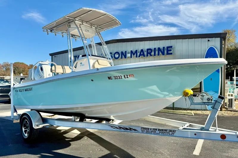 The Image of 2023 Key West 189 FS boat on trailer at dealership, clear sky background. - 1
