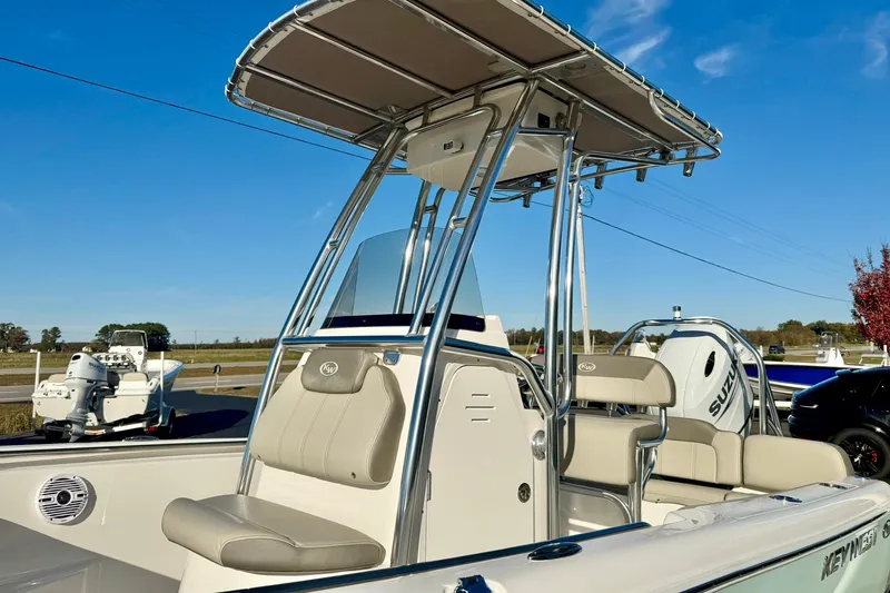Slide: The Image of 2023 Key West 189 FS boat with T-top and seating, parked outdoors. - 10