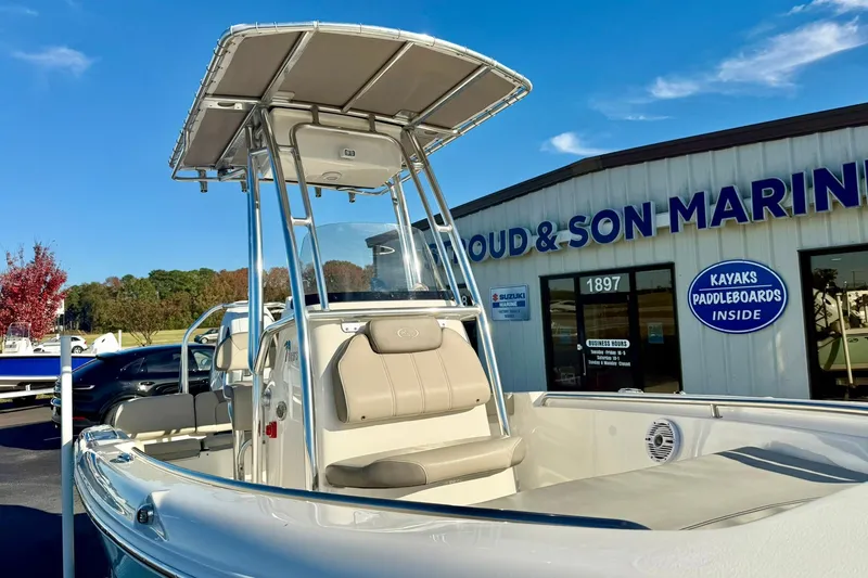 Slide: The Image of 2023 Key West 189 FS boat at a marine dealership under clear blue skies. - 11