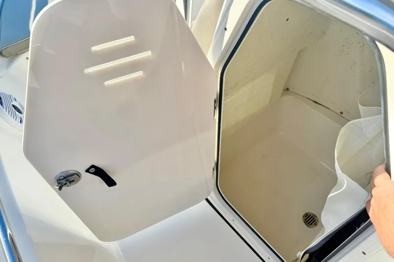 Slide: The Image of 2023 Key West 189 FS boat storage compartment with open door, showcasing interior space. - 23