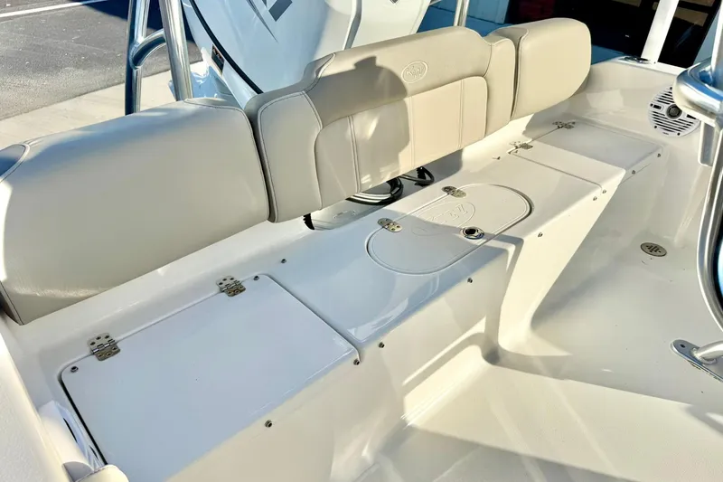 Slide: The Image of 2023 Key West 189 FS boat interior with cushioned seating and storage compartments. - 32