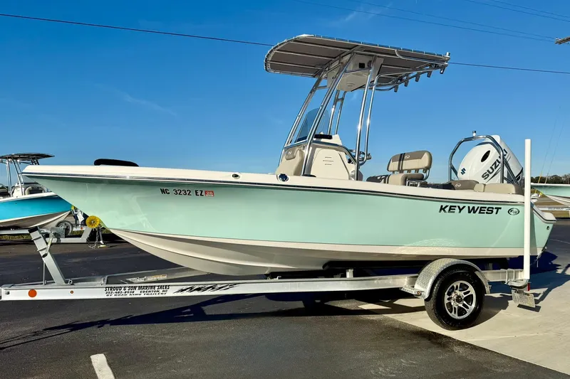 Slide: The Image of 2023 Key West 189 FS boat on trailer, displayed outdoors under clear blue sky. - 5