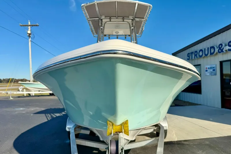 Slide: The Image of 2023 Key West 189 FS boat on trailer outside dealership under clear blue sky. - 8
