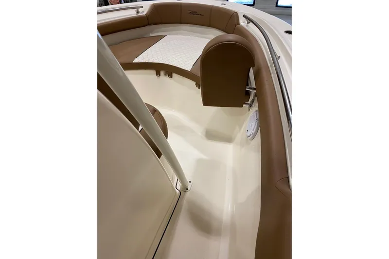 Slide: The Image of 2024 Pioneer 202 Islander boat interior with tan and white cushioned seating. - 13