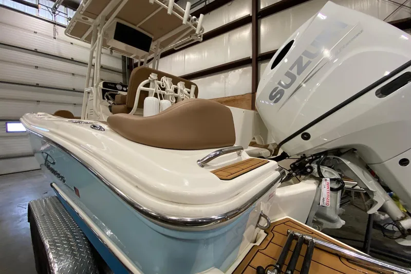 Slide: The Image of 2024 Pioneer 202 Islander boat in a garage, showcasing rear seating and engine. - 4