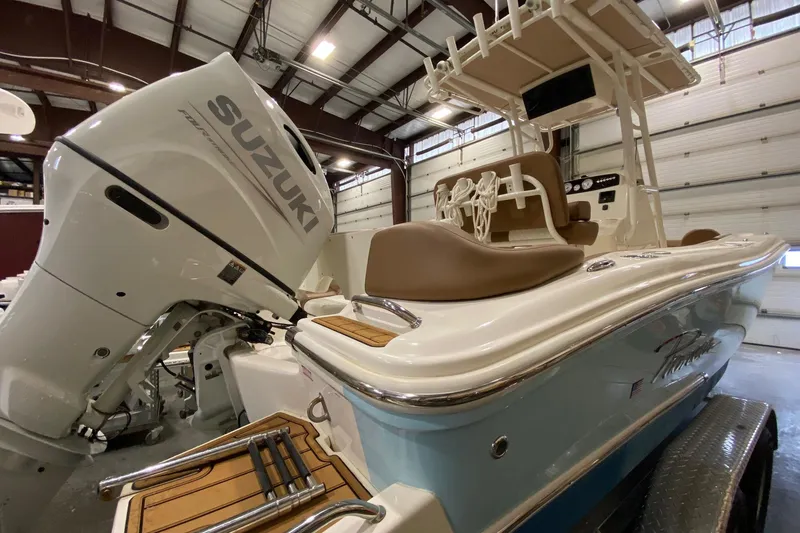 Slide: The Image of 2024 Pioneer 202 Islander boat dashboard with steering wheel, gauges, and controls. - 5