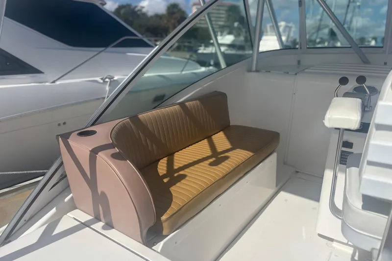 Slide: The Image of 2004 Luhrs 32 Open boat interior with tan seating and control panel. - 14