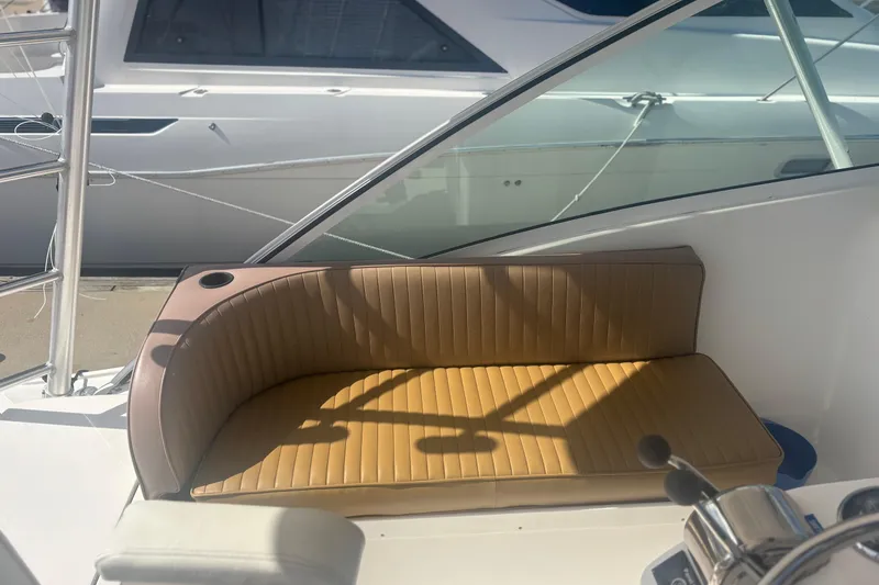 Slide: The Image of 2004 Luhrs 32 Open boat interior with tan cushioned seating and steering controls. - 15