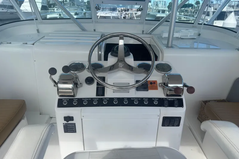Slide: The Image of Helm of 2004 Luhrs 32 Open boat with steering wheel and control panel. - 18