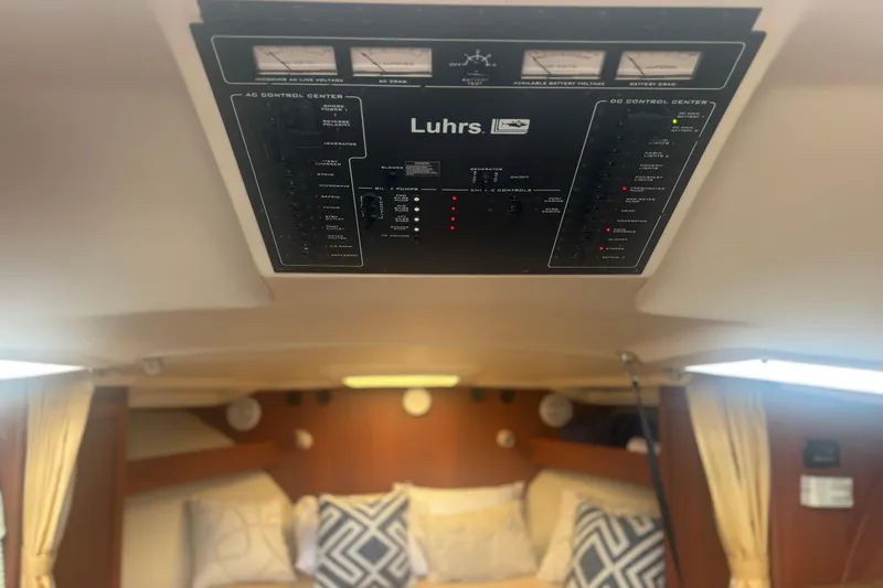 Slide: The Image of Control panel of a 2004 Luhrs 32 Open boat interior, with cozy cabin and pillows. - 23