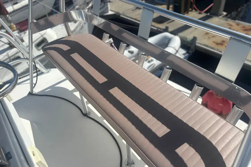 Slide: The Image of 2004 Luhrs 32 Open boat seating area with rod holders, docked at marina. - 8