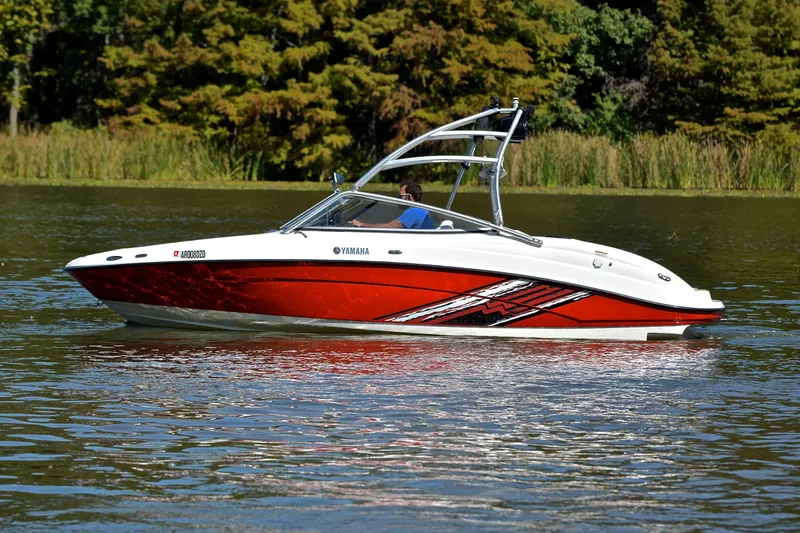 Slide: The Image of 2008 Yamaha AR210 boat on a lake, featuring a sleek red and white design. - 10
