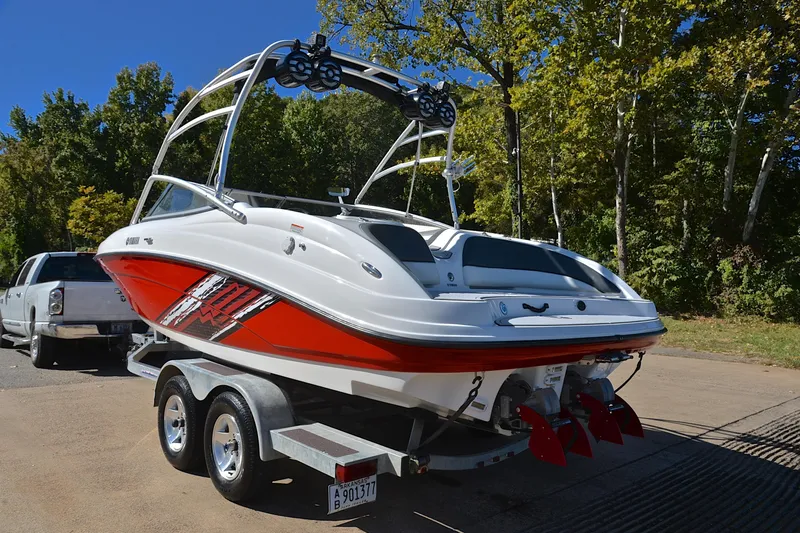 Slide: The Image of 2008 Yamaha Boats AR210 on trailer, parked outdoors with trees in background. - 13