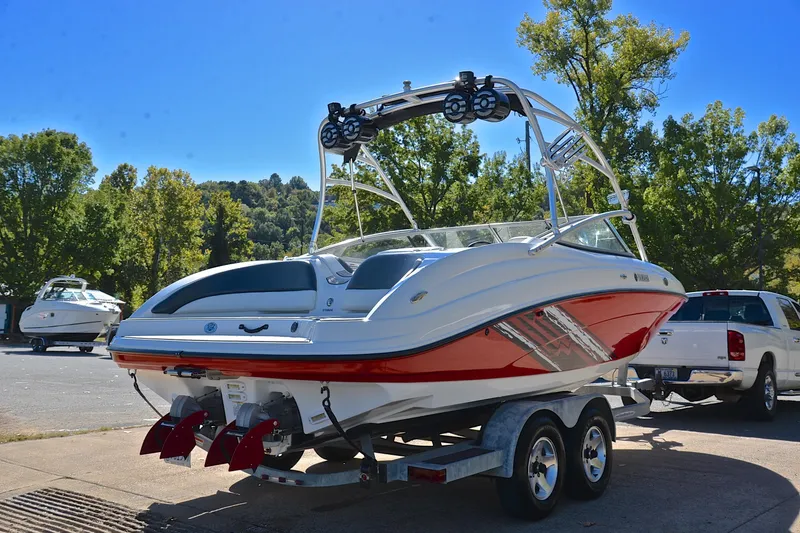 Slide: The Image of 2008 Yamaha Boats AR210 on trailer, parked outdoors with trees in background. - 15