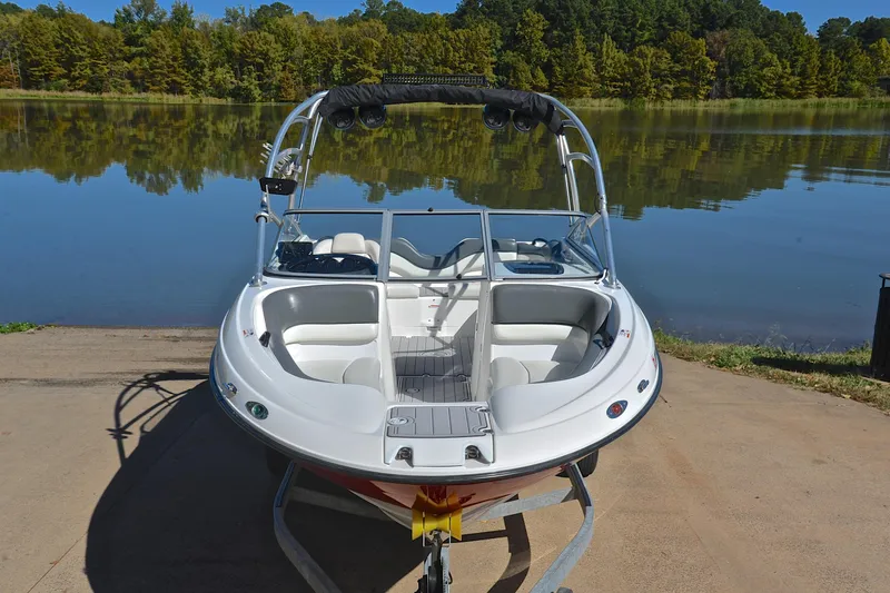 Slide: The Image of 2008 Yamaha Boats AR210 on trailer by a serene lake. - 18