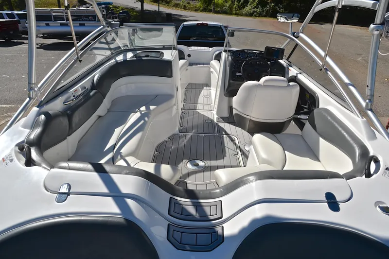 Slide: The Image of 2008 Yamaha Boats AR210 interior with white and gray seating, steering console, and open layout. - 19