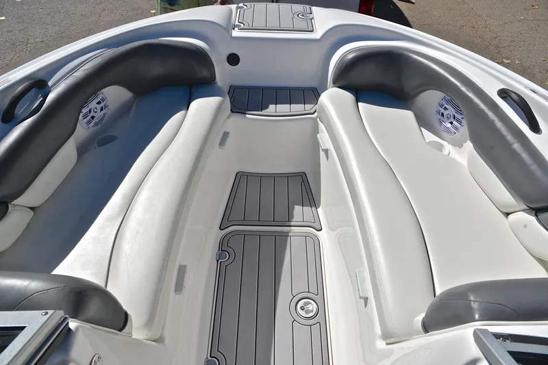 Slide: The Image of 2008 Yamaha AR210 boat interior with gray and white seating and flooring. - 22