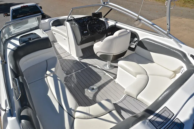 Slide: The Image of 2008 Yamaha Boats AR210 interior with white seating and modern dashboard. - 25