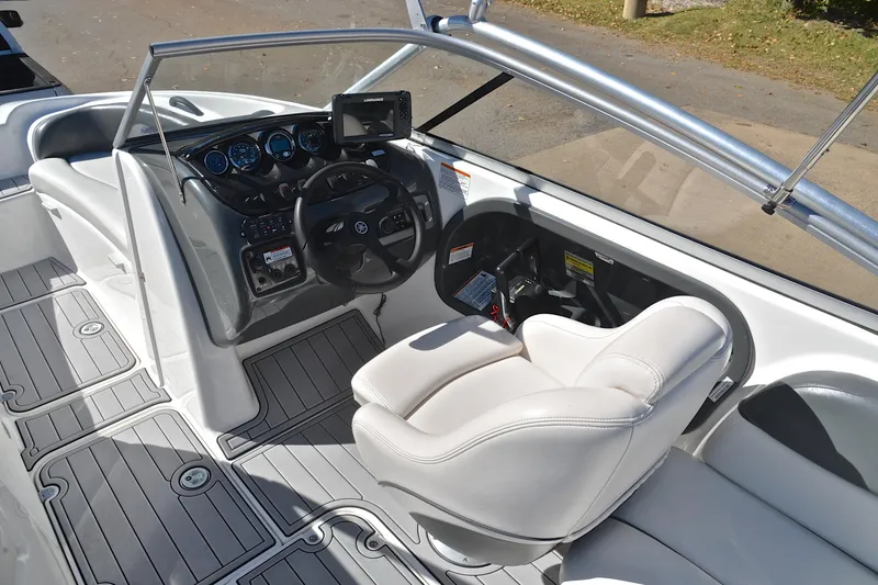Slide: The Image of 2008 Yamaha AR210 boat interior with steering wheel, dashboard, and white seating. - 26