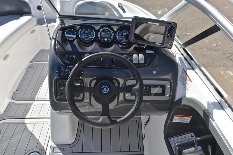 Slide: The Image of 2008 Yamaha AR210 boat dashboard with steering wheel and navigation system. - 27