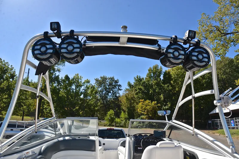 Slide: The Image of 2008 Yamaha AR210 boat with speakers and canopy, parked outdoors on a sunny day. - 29