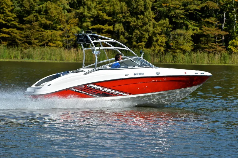 Slide: The Image of 2008 Yamaha AR210 boat speeding on a lake with lush green trees in the background. - 3